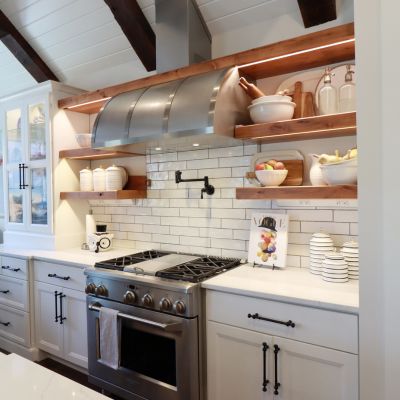 kitchen remodel with opoen wood shelving and large range hood